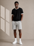 Model wearing black ringer t-shirt with grey shorts